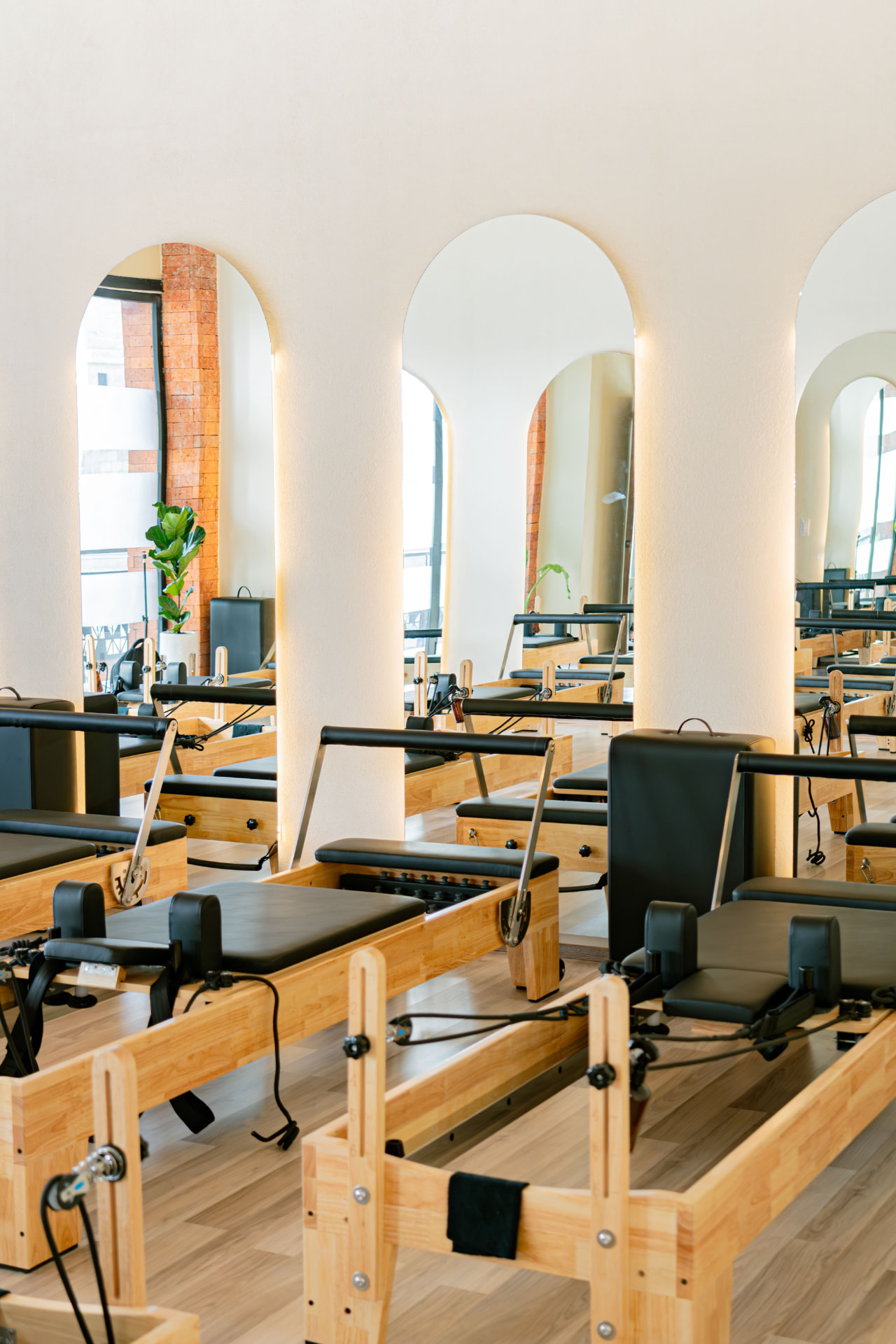 Airy pilates studio with wooden reformers